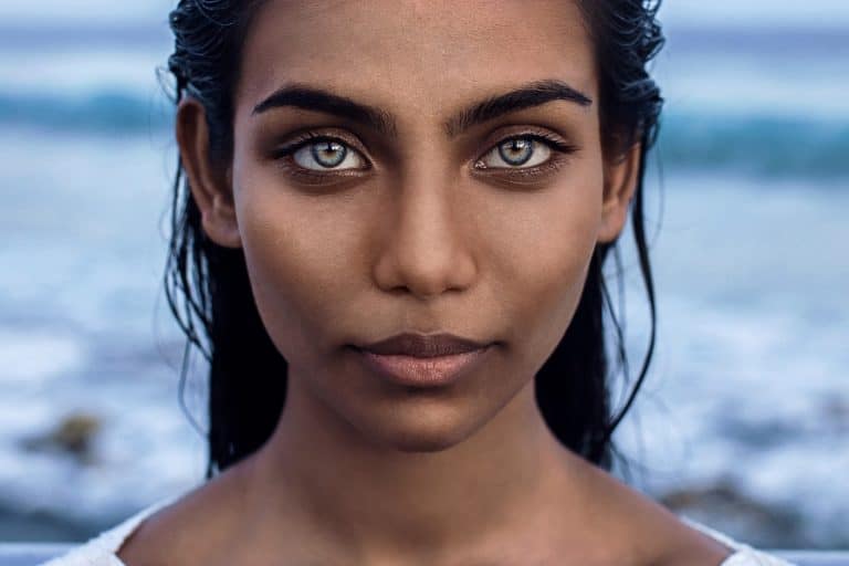 beautiful woman with green amazing eyes swimming in the ocean