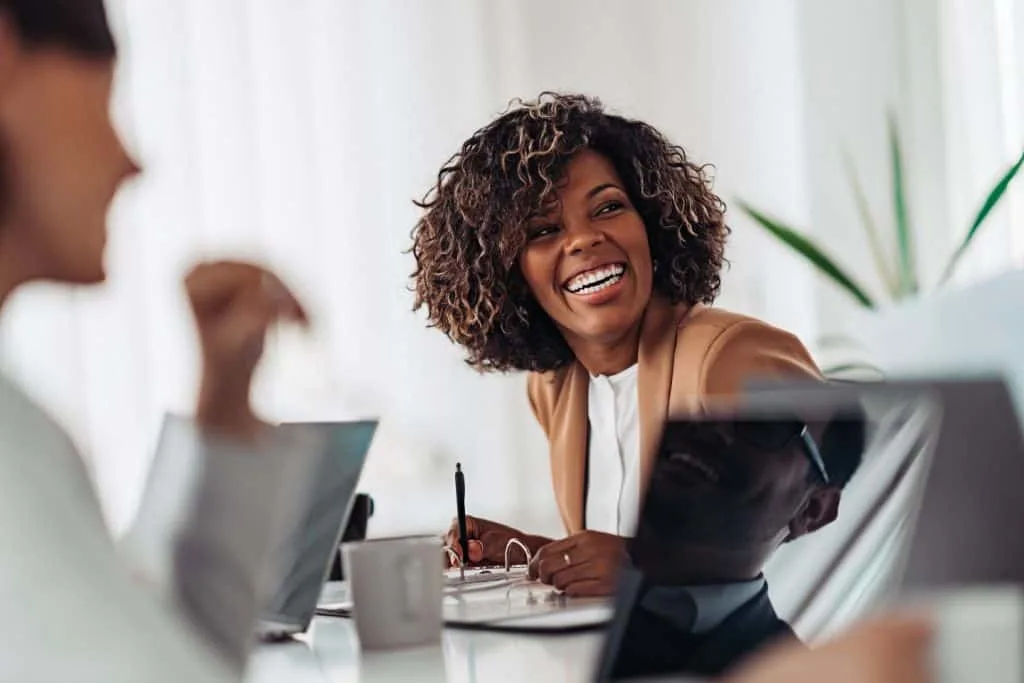 beautiful confident afroamerican woman smiling, she's working in an office