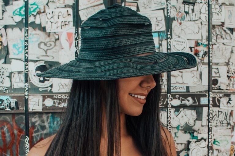 beautiful woman with long hair and dark green hat