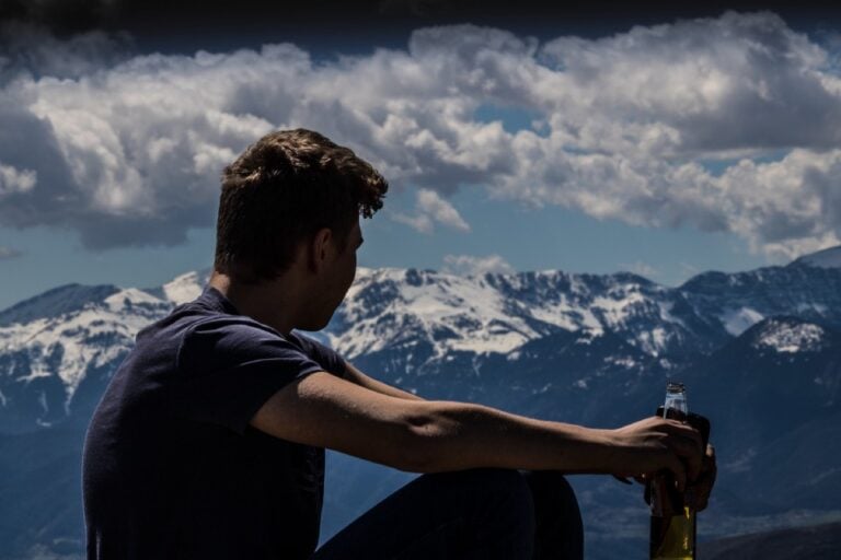 man looking away clouds in the background