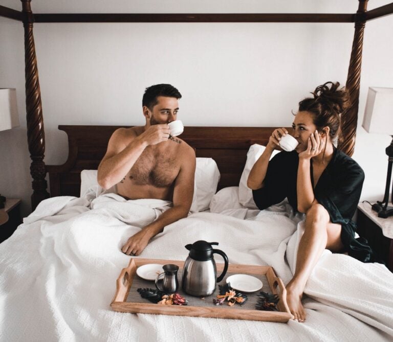 happy couple having breakfast in bed