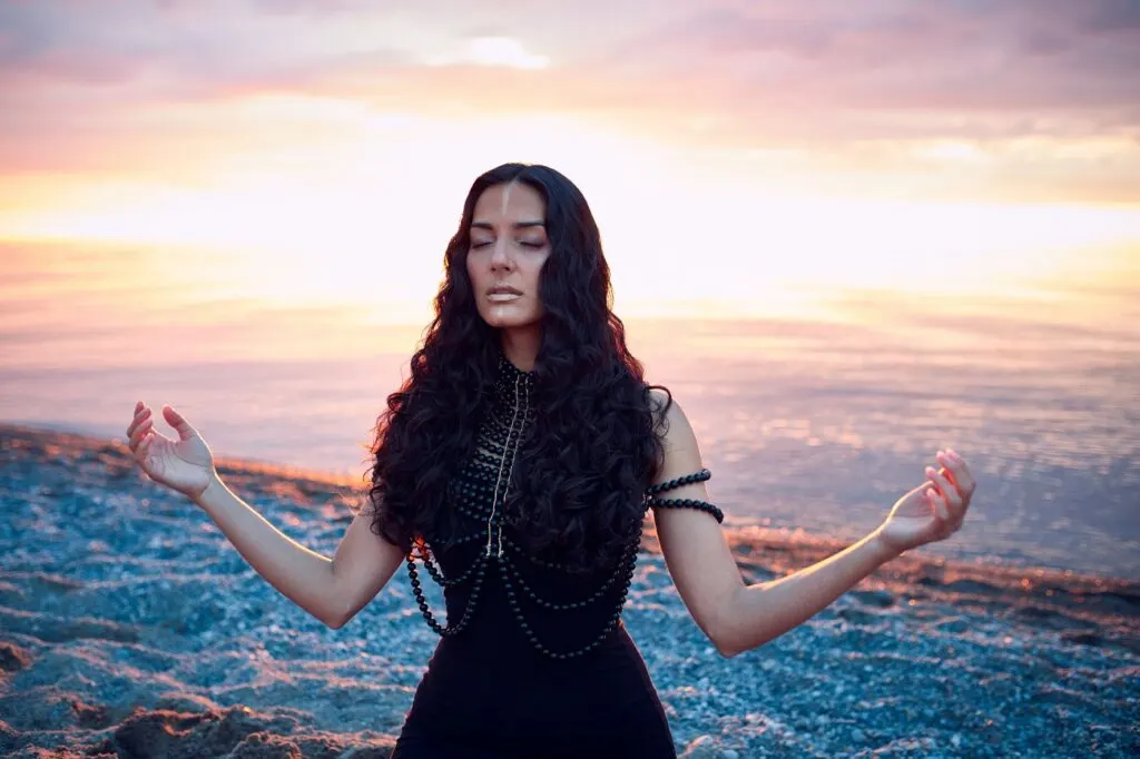 woman with long hair meditating in the nature