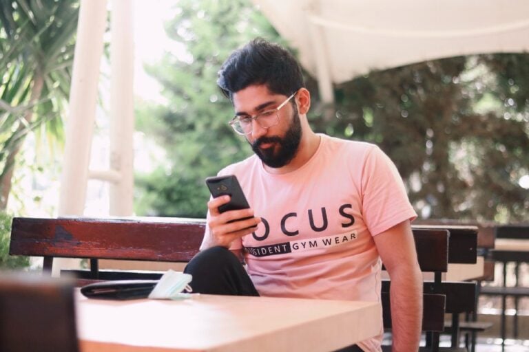 guy using Tinder on his phone