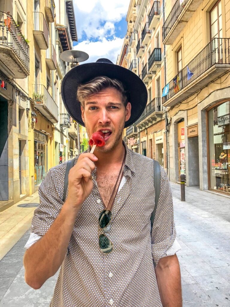 omega male walking in the street with a hat