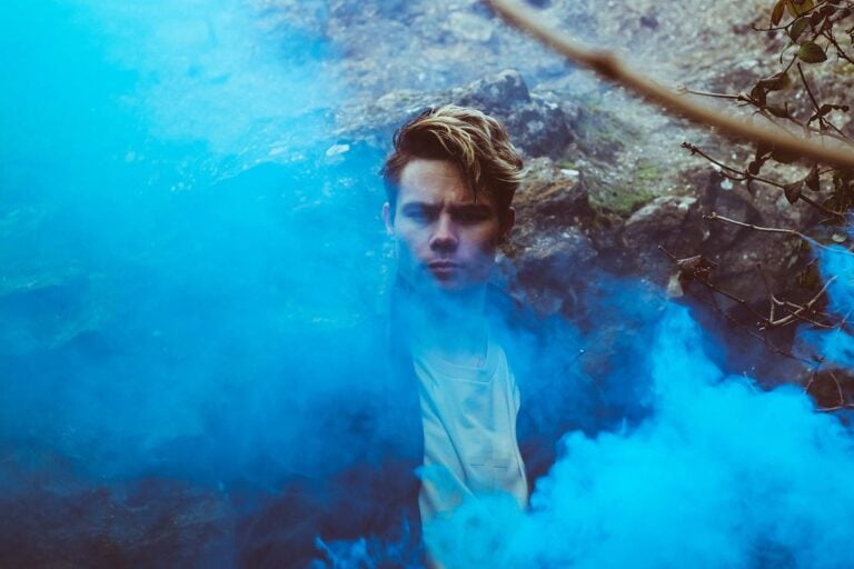 man behind blue smoke