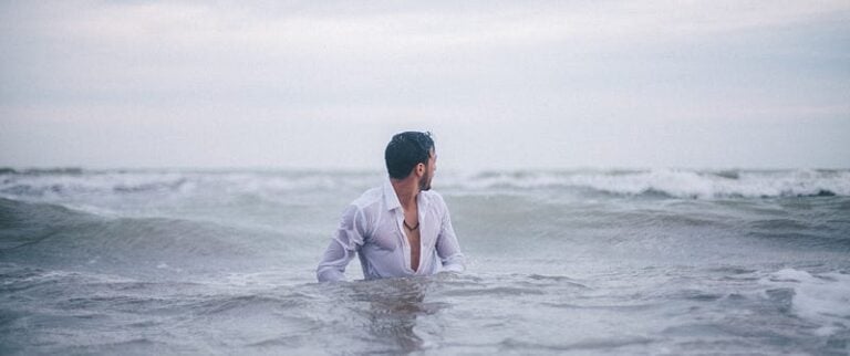 man with white shirt in the ocean