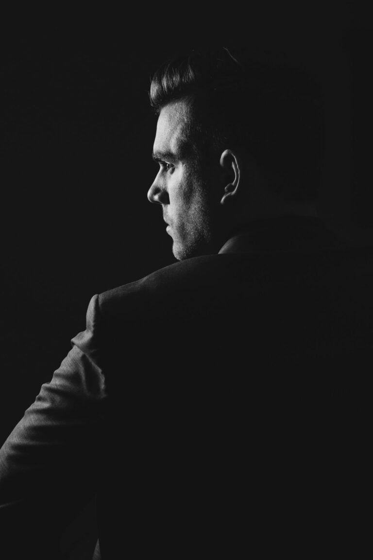 face of a man in the dark, black and white