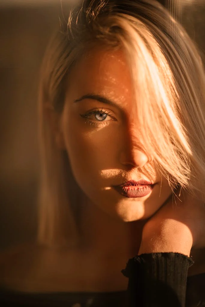 Captivating portrait of a blonde woman bathed in warm golden hour light.