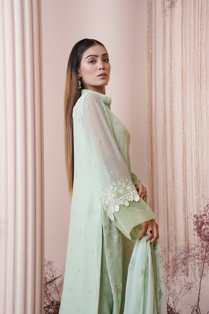 Captivating portrait of a young woman in a lavish mint green embroidered gown.