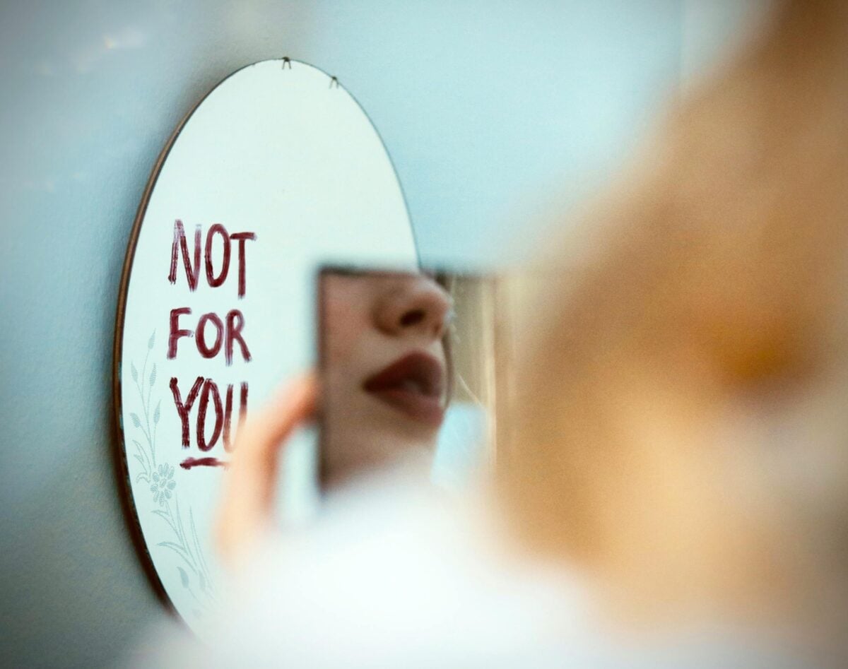 Artistic photo featuring a mirror reflection with 'Not for You' message, evoking mood and introspection.