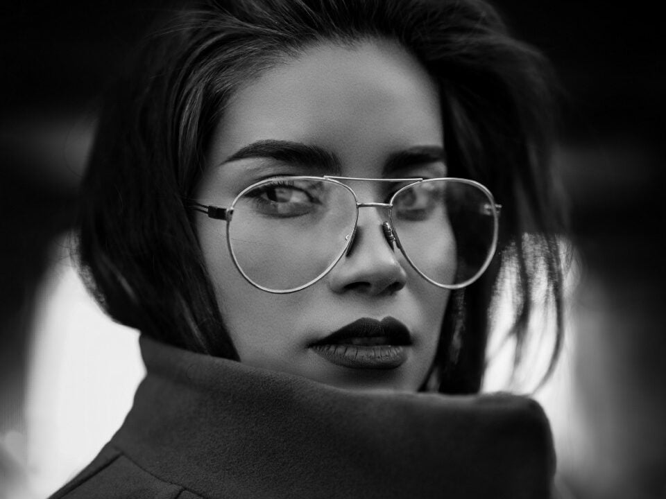 beautiful sigma female with glasses and long hair with dark coat