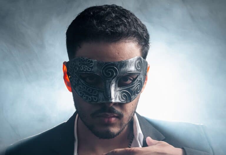 A man wearing an intricate mask and suit, exuding a mysterious and stylish aura.