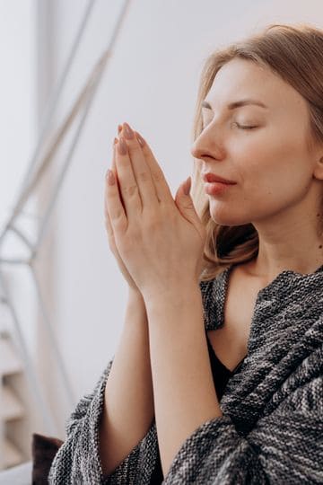 A serene woman praying.