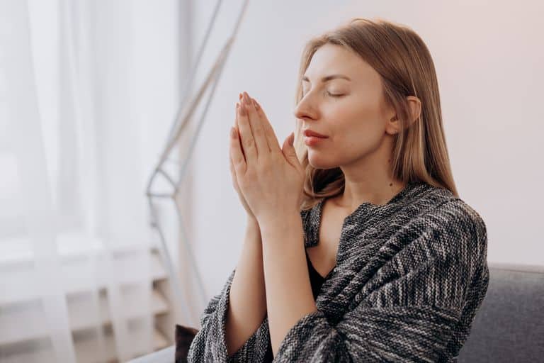 A serene woman praying.