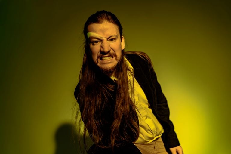 Artistic portrait of a man with dramatic lighting and a fierce expression.