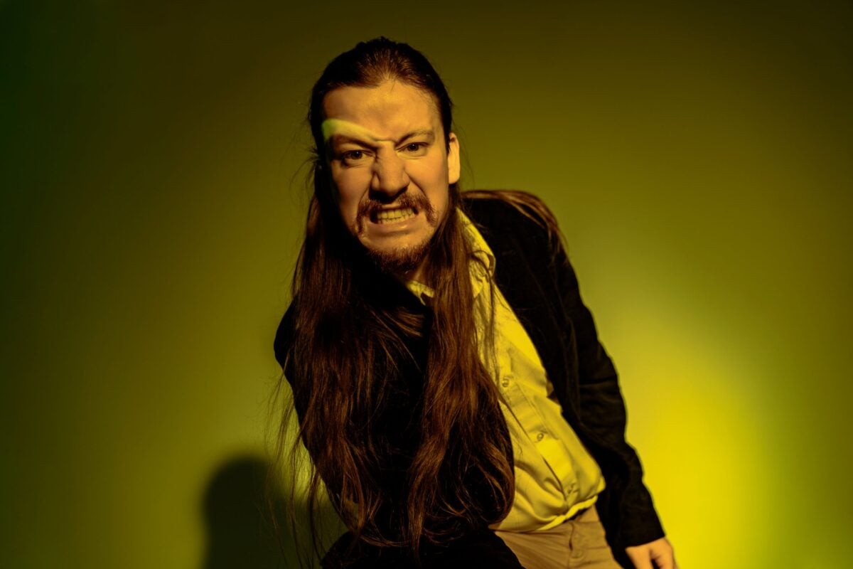 Artistic portrait of a man with dramatic lighting and a fierce expression.