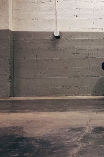 A person sitting alone in a corner, evoking themes of solitude and emotion.