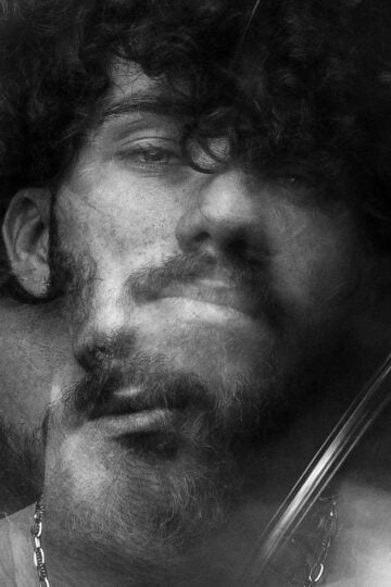 Ethereal black and white portrait featuring a blurred double exposure effect.