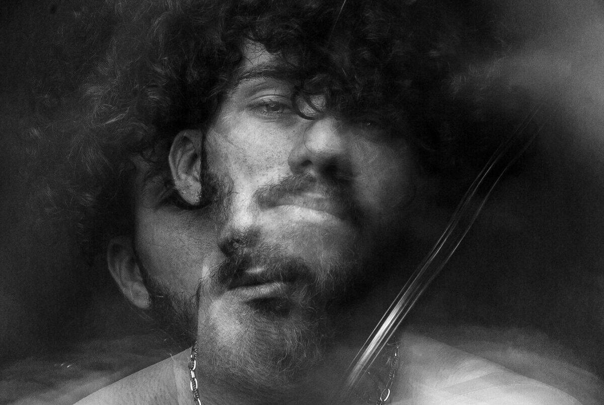 Ethereal black and white portrait featuring a blurred double exposure effect.