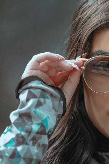 Fashionable woman in Tehran showcasing glamorous sunglasses, emphasizing modern eyewear style.