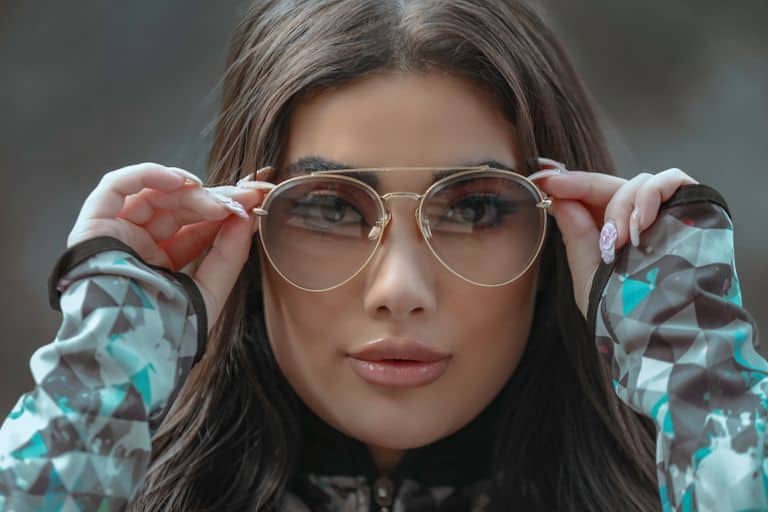 Fashionable woman in Tehran showcasing glamorous sunglasses, emphasizing modern eyewear style.
