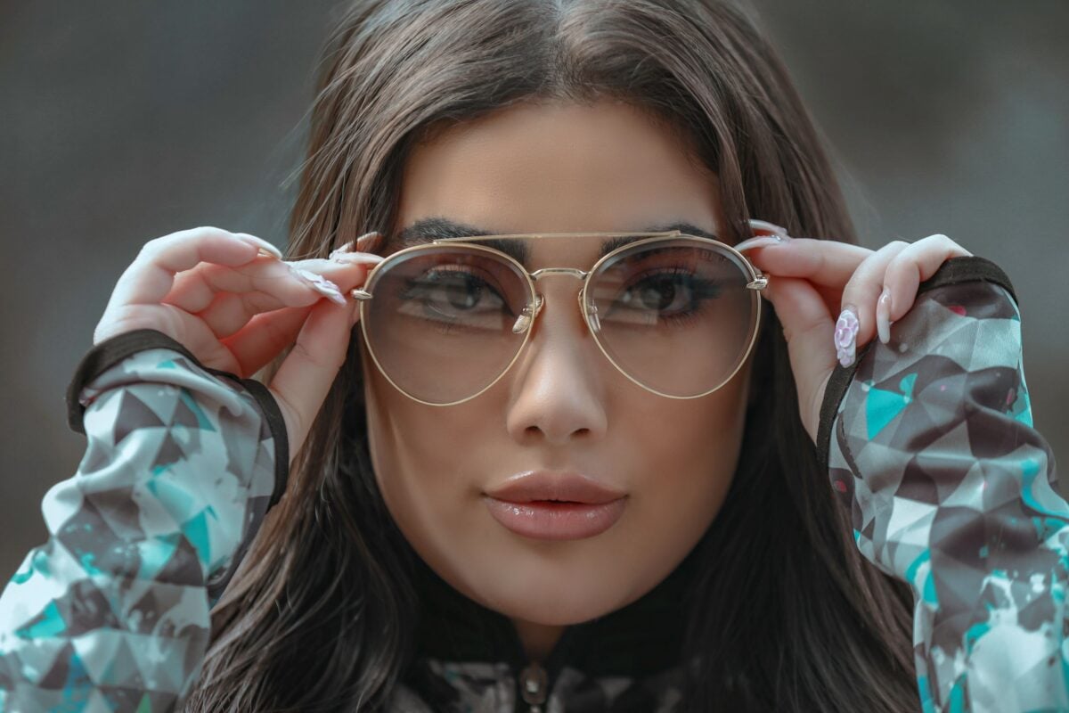 Fashionable woman in Tehran showcasing glamorous sunglasses, emphasizing modern eyewear style.
